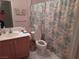 Full bathroom with floral shower curtain, vanity, and neutral walls at 2148 Hidden Ranch Ter, Henderson, NV 89052