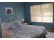 Comfortable bedroom with a decorative bed frame and a large window for natural light at 2148 Hidden Ranch Ter, Henderson, NV 89052
