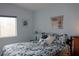 Serene bedroom with blue walls, a floral bedspread, and soft natural light at 2148 Hidden Ranch Ter, Henderson, NV 89052