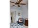 Cozy bedroom featuring a vaulted ceiling, ceiling fan, and chair with personal touches at 2148 Hidden Ranch Ter, Henderson, NV 89052