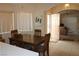 Inviting dining area featuring a wooden table set near the front entrance and a view into the living room at 2148 Hidden Ranch Ter, Henderson, NV 89052