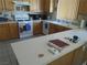 Functional kitchen with white appliances, ample counter space, and light wood cabinetry at 2148 Hidden Ranch Ter, Henderson, NV 89052