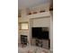 Spacious living room featuring a fireplace, TV, and decorative shelving above at 2148 Hidden Ranch Ter, Henderson, NV 89052
