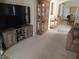 Spacious living room featuring modern entertainment center and view into the dining area and kitchen at 2148 Hidden Ranch Ter, Henderson, NV 89052