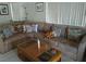 Comfortable living room featuring a large sectional sofa and bright, natural light from the window at 2148 Hidden Ranch Ter, Henderson, NV 89052