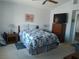Well-lit main bedroom with a queen bed, warm wood furniture, and lots of natural light at 2148 Hidden Ranch Ter, Henderson, NV 89052