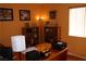 Well-lit home office featuring a large desk, bookshelves, and warm, inviting colors at 2148 Hidden Ranch Ter, Henderson, NV 89052