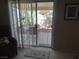 View of the outdoor patio, accessible through sliding glass doors, showcasing an outdoor dining set at 2148 Hidden Ranch Ter, Henderson, NV 89052