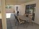 Relaxing covered patio area with dining table, grill, and view of the landscaped backyard at 2148 Hidden Ranch Ter, Henderson, NV 89052