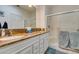 Bathroom featuring double sinks with granite countertop, white cabinetry and a shower at 2164 Eagle Sticks Dr, Henderson, NV 89012