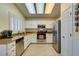 Bright kitchen featuring stainless steel appliances, granite countertops, white cabinets, and tile flooring at 2164 Eagle Sticks Dr, Henderson, NV 89012