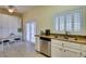 Eat-in kitchen with a granite counter, white cabinets, stainless steel appliances, and a sliding door to the patio at 2164 Eagle Sticks Dr, Henderson, NV 89012