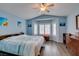 Main bedroom with blue walls, wood floors, bay window, ceiling fan, and wood furniture at 2164 Eagle Sticks Dr, Henderson, NV 89012