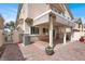 Charming backyard with a covered patio, brick flooring, and manicured landscaping at 2295 Koho Dr # 102, Las Vegas, NV 89183