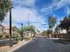 Community entrance featuring landscaped grounds, a gated entrance, and well-maintained roads at 2295 Koho Dr # 102, Las Vegas, NV 89183