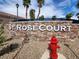 St. Rose Court community sign with a stone base, beautiful landscaping, and bright signage at 2295 Koho Dr # 102, Las Vegas, NV 89183