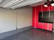 Garage with gray epoxy flooring, ample storage space, and red cabinets at 2295 Koho Dr # 102, Las Vegas, NV 89183