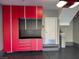 Garage with gray epoxy flooring and red storage cabinets with water-softening appliance at 2295 Koho Dr # 102, Las Vegas, NV 89183
