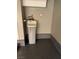 Garage interior featuring a water softening appliance and epoxy flooring at 2295 Koho Dr # 102, Las Vegas, NV 89183