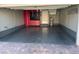 Spacious garage with epoxy flooring and installed red cabinets and storage system at 2295 Koho Dr # 102, Las Vegas, NV 89183