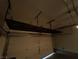 Garage with an overhead storage rack and an open door at 2295 Koho Dr # 102, Las Vegas, NV 89183