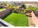 A backyard featuring a spacious lawn and nicely designed retaining wall at 23 Strada Barbera, Henderson, NV 89011