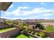 Backyard features well manicured landscaping, green grass and surrounding homes at 23 Strada Barbera, Henderson, NV 89011