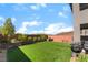 The home's backyard contains an outdoor grill, immaculate lawn, and patio at 23 Strada Barbera, Henderson, NV 89011