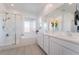 Bright bathroom featuring dual sinks, stand up shower and a bathtub at 23 Strada Barbera, Henderson, NV 89011