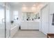 Bathroom featuring dual sinks, bright lighting, a tub and stand up shower at 23 Strada Barbera, Henderson, NV 89011