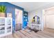 Inviting entryway with blue accent wall, stylish decor, and wood-look tile flooring at 23 Strada Barbera, Henderson, NV 89011
