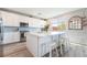 Stylish kitchen with white cabinets, stainless appliances, large island with seating, and modern finishes at 23 Strada Barbera, Henderson, NV 89011
