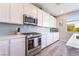 Modern kitchen features stainless steel appliances, white cabinets, and a light backsplash at 23 Strada Barbera, Henderson, NV 89011