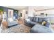 Open-concept living room with comfortable seating, wood-look floors, and easy access to the kitchen at 23 Strada Barbera, Henderson, NV 89011