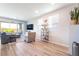 Cozy living room with sliding glass doors, stylish furniture, and wood-look floors at 23 Strada Barbera, Henderson, NV 89011
