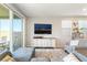 Bright living room with outdoor access, comfortable seating arrangement, and sleek wood-look flooring at 23 Strada Barbera, Henderson, NV 89011