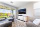 Relaxing living room with patio access, comfortable seating, and bright, airy feel at 23 Strada Barbera, Henderson, NV 89011