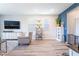 Comfortable living room featuring modern furnishings, wood-look tile floors, and plenty of natural light at 23 Strada Barbera, Henderson, NV 89011