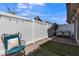 Cozy backyard patio featuring white fencing, chairs, and artificial turf at 236 Callen Falls Ave # 1211, Henderson, NV 89011