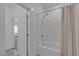 Bright bathroom with white tiled shower and neutral-striped shower curtain at 236 Callen Falls Ave # 1211, Henderson, NV 89011