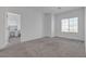 Spacious bedroom with a large window offering natural light, features neutral walls and soft carpeting at 236 Callen Falls Ave # 1211, Henderson, NV 89011