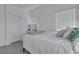 Bright bedroom showcasing a bed with grey and green pillows with two windows at 236 Callen Falls Ave # 1211, Henderson, NV 89011