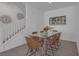 Bright dining room featuring stairs to second floor, art on wall, and glass table at 236 Callen Falls Ave # 1211, Henderson, NV 89011