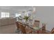 Open-concept layout showcasing the dining area with a glass table, seamlessly connecting to the living room at 236 Callen Falls Ave # 1211, Henderson, NV 89011