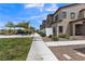 View of townhome exteriors with community green spaces, manicured landscaping, and walkways at 236 Callen Falls Ave # 1211, Henderson, NV 89011