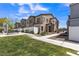 View of townhome exteriors with community green spaces, manicured landscaping, and walkways at 236 Callen Falls Ave # 1211, Henderson, NV 89011