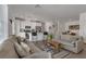 Open-concept living room and kitchen area with white cabinets and modern decor at 236 Callen Falls Ave # 1211, Henderson, NV 89011