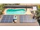 Aerial shot showcases the backyard's pool, sunshade, along with home's solar panels at 2426 La Pluma St, Henderson, NV 89014