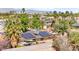 Backyard view featuring a pool, lounge seating, sunshade, solar panels, and desert landscaping at 2426 La Pluma St, Henderson, NV 89014