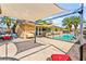 Backyard featuring a swimming pool, shaded patio, and ample seating at 2426 La Pluma St, Henderson, NV 89014